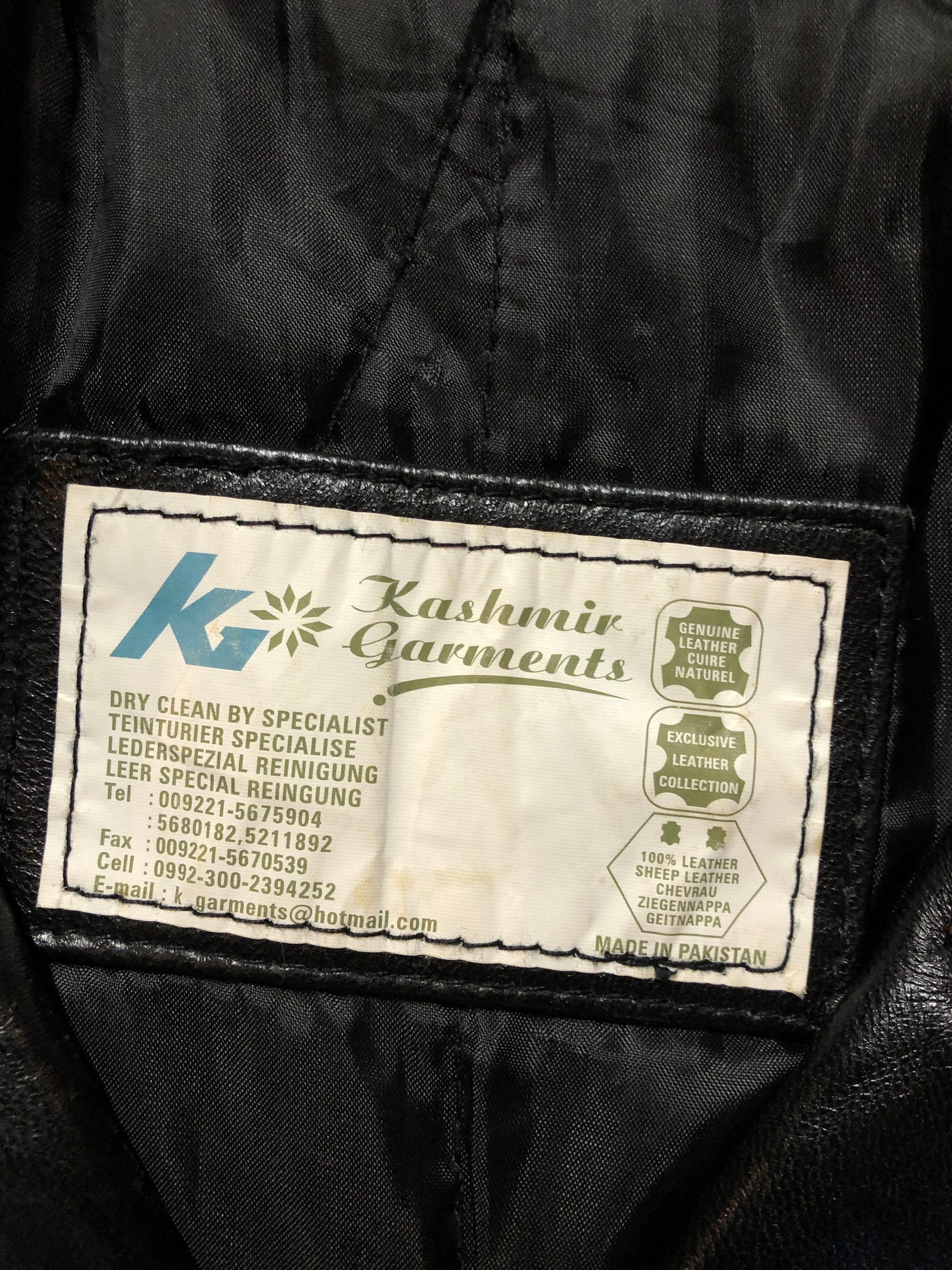 Kingspier Vintage - Kashmir Garments black leather jacket features two flap pockets on the chest with hidden chain detail underneath and skull button closures. Size medium.