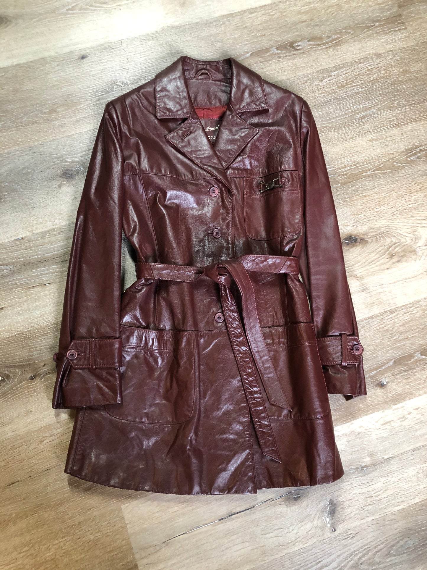 Kingspier Vintage - Etienne Aguier burgundy leather jacket with button closures, patch pockets, belt and “A” decorative details. Size small.