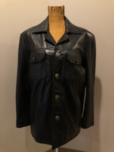 Load image into Gallery viewer, Kingspier Vintage - Kashmir Garments black leather jacket features two flap pockets on the chest with hidden chain detail underneath and skull button closures. Size medium.
