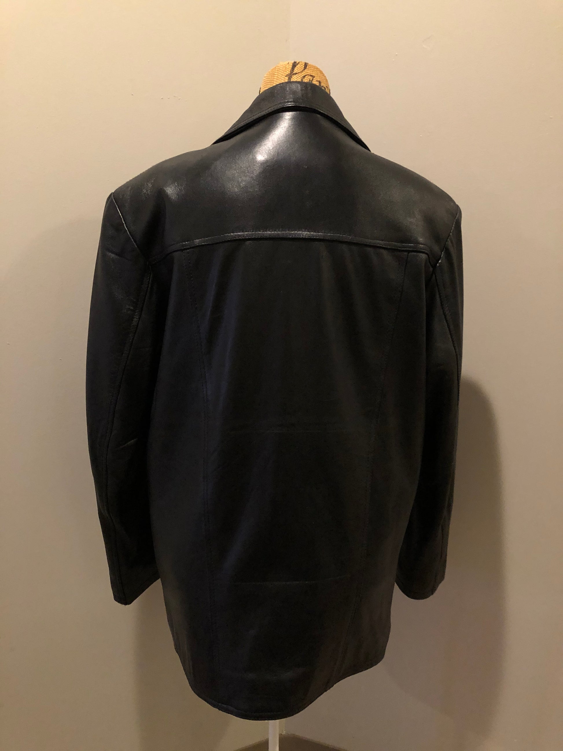 Kingspier Vintage - Kashmir Garments black leather jacket features two flap pockets on the chest with hidden chain detail underneath and skull button closures. Size medium.