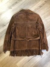 Load image into Gallery viewer, Kingspier Vintage - Jonathan Legault brown suede western style jacket with fringe details, belt in the back, button closures and slash pockets. 
