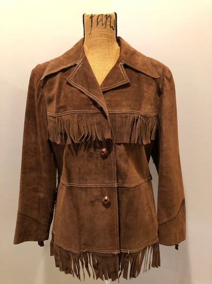 Kingspier Vintage - Jonathan Legault brown suede western style jacket with fringe details, belt in the back, button closures and slash pockets. 