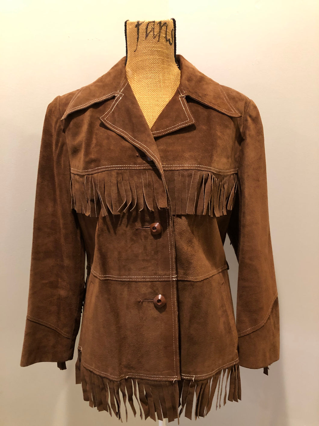 Kingspier Vintage - Jonathan Legault brown suede western style jacket with fringe details, belt in the back, button closures and slash pockets. 