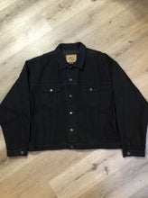 Load image into Gallery viewer, Kingspier Vintage - International Denim black denim jacket with button closures, two vertical pockets, two flap pockets and two inside pockets. Made in Canada. Size XXXL. 
