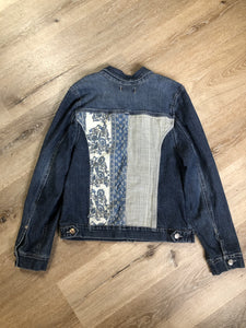Kingspier Vintage - Nine West Vintage Collection denim jacket in a medium wash with vintage look material piece in the back, button clusters, two vertical pockets and two flap pockets on the chest. Size large.