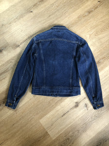 Kingspier Vintage - Lee denim jacket in a medium wash with unique stitching going down the Center front, button closures and two flap pockets on the chest. Union made in the USA. Size 8.