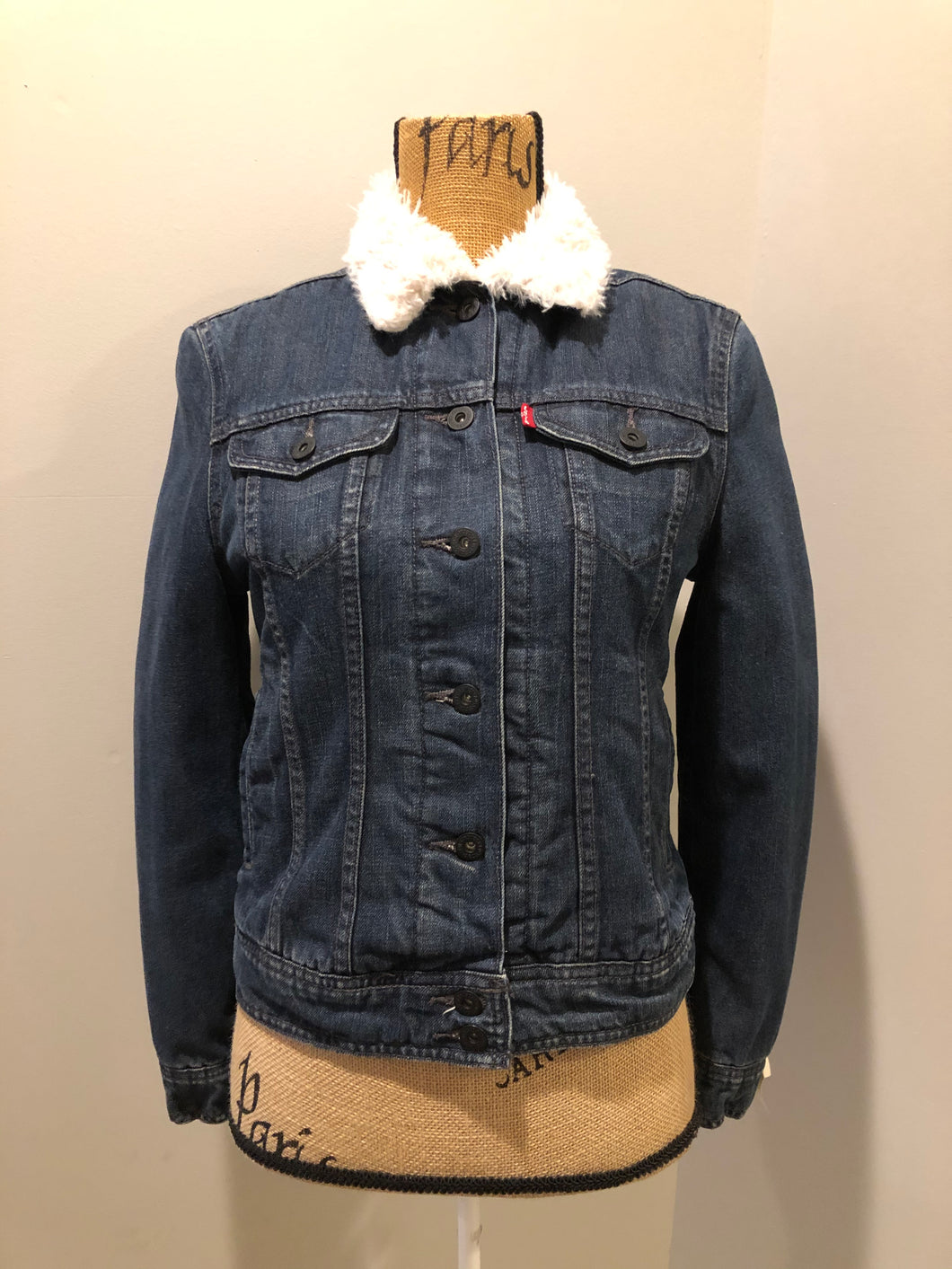 Kingspier Vintage - Levi’s denim Sherpa jacket in a faded dark wash with button closures, vertical pockets and flap pockets. Size small.
