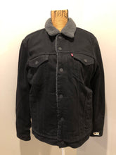 Load image into Gallery viewer, Kingspier Vintage - Levi’s denim sherpa jacket in black with grey faux fur lining, snap closures, vertical pockets, two flap pockets on the chest. Size medium
