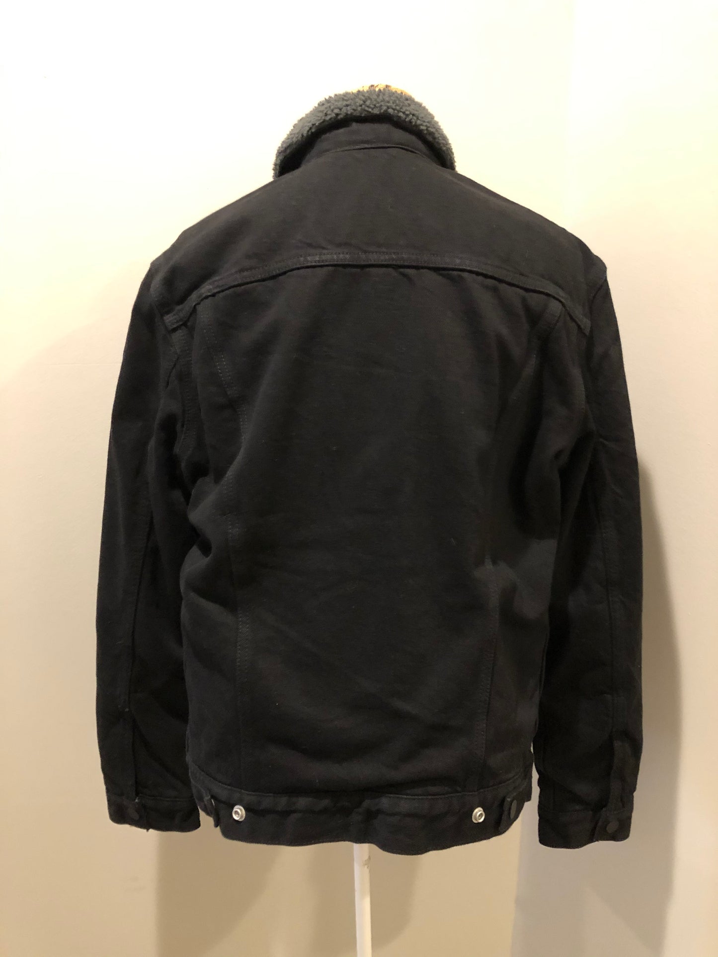 Kingspier Vintage - Levi’s denim sherpa jacket in black with grey faux fur lining, snap closures, vertical pockets, two flap pockets on the chest. Size medium