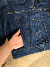 Load image into Gallery viewer, Kingspier Vintage - Levi’s denim jacket in a medium wash with button closures, hand warmer pockets, size medium.

