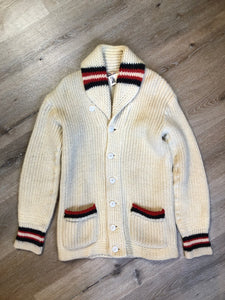 Kingspier Vintage - Curl-Rite by Rice-Knit Sportswear 1950’s curing sweater in cream with red and black strip details, shawl collar, button closures and pockets. 100% wool. Size medium. Made in Nova Scotia. 