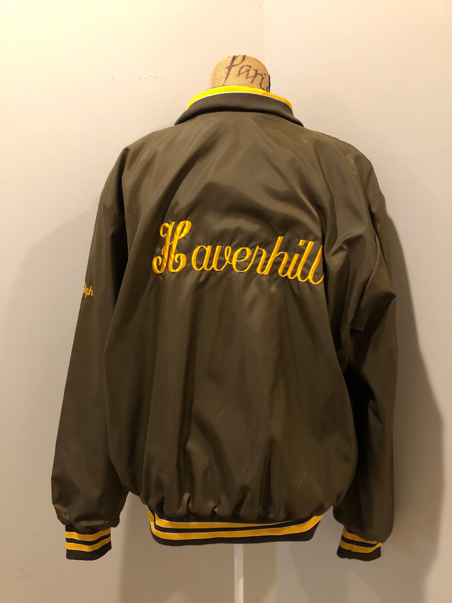 Kingspier Vintage - Havenhill High Soccer varsity jacket in brown with yellow stripe, zipper, front pouch pocket, “Havenhill High” written across the back and “Steph” monogram on the arm. Made in the USA. Size large. 