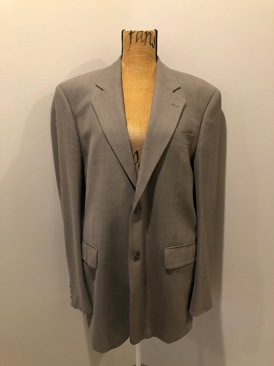 Kingspier Vintage - WM.H. Leishman (sold at Tip Top Tailors) two piece medium grey 100% pure virgin wool suit.The jacket is a single breasted, two button notch lapel with two flap pockets and two inside pockets. Pants are pleated with welt pockets. Made in Canada. 