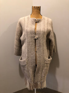Kingspier Vintage - Daurene Lewis 100% wool hand spun, hand woven and hand made cardigan. The cardigan features two lined patch pockets. two wooden button closures at the top and a wool fringe at the bottom. Made in Annapolis Royal, Nova Scotia.