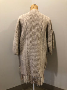 Kingspier Vintage - Daurene Lewis 100% wool hand spun, hand woven and hand made cardigan. The cardigan features two lined patch pockets. two wooden button closures at the top and a wool fringe at the bottom. Made in Annapolis Royal, Nova Scotia.