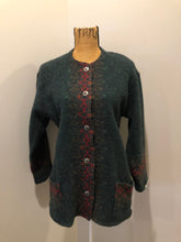 Load image into Gallery viewer, Kingspier Vintage - Deweevers wovens 100% wool cardigan in deep green with red design woven in, patch pockets and silver buttons with floral design. Made in Aylesford, NS. Size medium.

