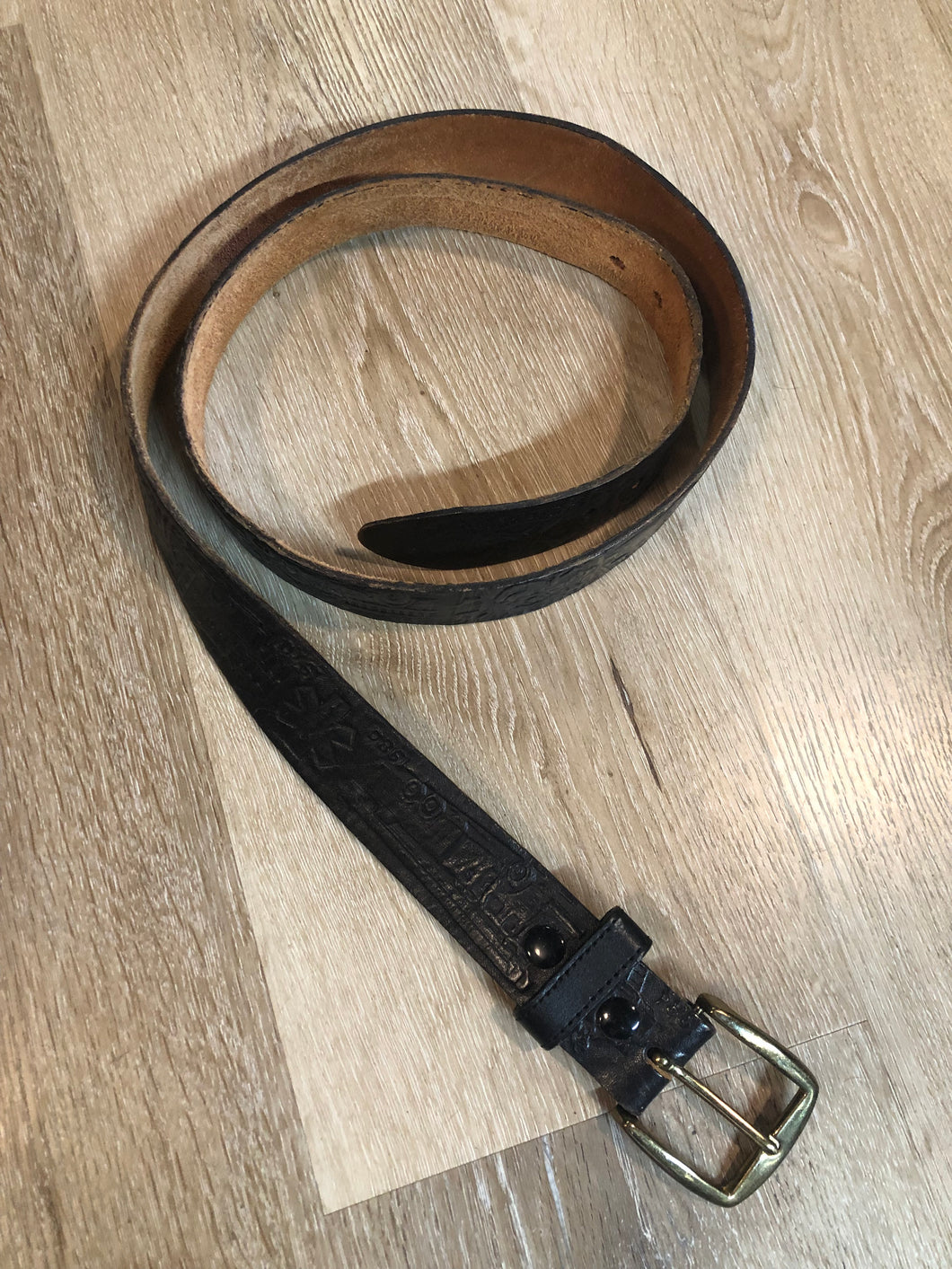 Kingspier Vintage - Vintage Noma Leather black full grain leather firefighter belt with brass buckle and embossed illustration of the evolution of the fire truck from 1922-1984. Made in Canada