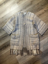 Load image into Gallery viewer, Kingspier Vintage - Daurene Lewis 100% wool hand spun, hand woven and hand made cardigan. The cardigan features two lined patch pockets. two wooden button closures at the top and a wool fringe at the bottom. Made in Annapolis Royal, Nova Scotia.

