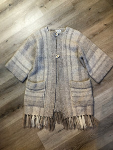 Kingspier Vintage - Daurene Lewis 100% wool hand spun, hand woven and hand made cardigan. The cardigan features two lined patch pockets. two wooden button closures at the top and a wool fringe at the bottom. Made in Annapolis Royal, Nova Scotia.