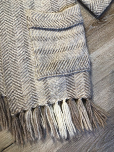 Kingspier Vintage - Daurene Lewis 100% wool hand spun, hand woven and hand made cardigan. The cardigan features two lined patch pockets. two wooden button closures at the top and a wool fringe at the bottom. Made in Annapolis Royal, Nova Scotia.