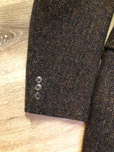 Load image into Gallery viewer, Kingspier Vintage - Harris Tweed brown and blue herringbone 100% wool jacket. This jacket is a three button, notch lapel with two flap pockets, a breast pocket and three inside pockets. Made in the Czech Republic.
