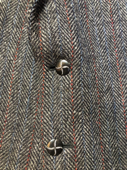 Kingspier Vintage - Harris Tweed grey herringbone with subtle red and blue stripe 100% wool jacket. This jacket is a two button, notch lapel with two patch pockets, a breast pocket and three inside pockets.