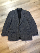 Load image into Gallery viewer, Kingspier Vintage - Harris Tweed black and white 100% wool tweed jacket. This jacket is a two button, notch lapel with two flap pockets, a breast pocket and two inside pockets. Made in Canada. Size 40.
