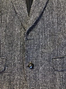 Kingspier Vintage - Harris Tweed black and white 100% wool tweed jacket. This jacket is a two button, notch lapel with two flap pockets, a breast pocket and two inside pockets. Made in Canada. Size 40.