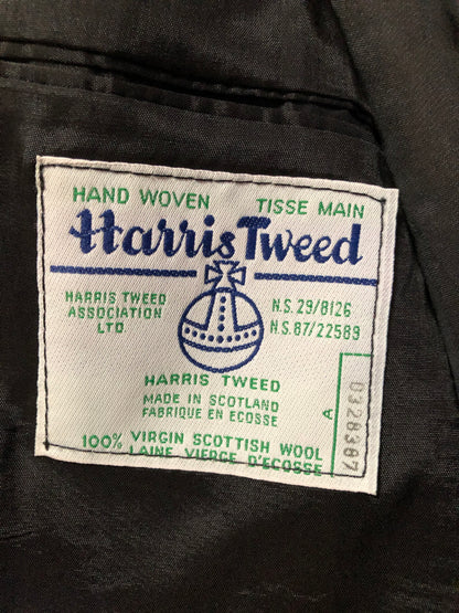 Kingspier Vintage - Harris Tweed black and white 100% wool tweed jacket. This jacket is a two button, notch lapel with two flap pockets, a breast pocket and two inside pockets. Made in Canada. Size 40.