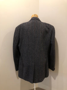 Kingspier Vintage - Harris Tweed grey herringbone with subtle red and blue stripe 100% wool jacket. This jacket is a two button, notch lapel with two patch pockets, a breast pocket and three inside pockets.
