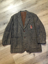 Load image into Gallery viewer, Kingspier Vintage - Donegal handwoven grey with blue and orange flecks 100% wool tweed jacket. This jacket is a two button, notch lapel with two patch pockets, a breast pocket and two inside pockets and a “this I defend” emblem embroidered on the chest. Made in Ireland.
