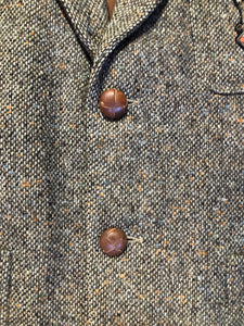 Kingspier Vintage - Donegal handwoven grey with blue and orange flecks 100% wool tweed jacket. This jacket is a two button, notch lapel with two patch pockets, a breast pocket and two inside pockets and a “this I defend” emblem embroidered on the chest. Made in Ireland.