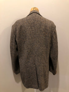 Kingspier Vintage - Donegal handwoven grey with blue and orange flecks 100% wool tweed jacket. This jacket is a two button, notch lapel with two patch pockets, a breast pocket and two inside pockets and a “this I defend” emblem embroidered on the chest. Made in Ireland.