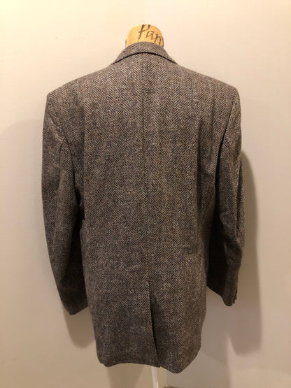 Kingspier Vintage - Paul Henry grey herringbone with flecks blue and rust 100% wool tweed jacket. This jacket is a two button, notch lapel with two flap pockets, a breast pocket and three inside pockets. Made in Europe.