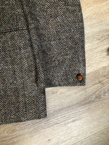 Kingspier Vintage - Paul Henry grey herringbone with flecks blue and rust 100% wool tweed jacket. This jacket is a two button, notch lapel with two flap pockets, a breast pocket and three inside pockets. Made in Europe.
