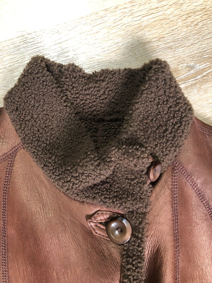 Kingspier Vintage - Rosa Mori by Irma Taylor medium brown shearling coat. This coat features a bronze iridescent finish, shearling trim and lining, button closures and slash pockets. Made in Montreal, Canada, Size medium.