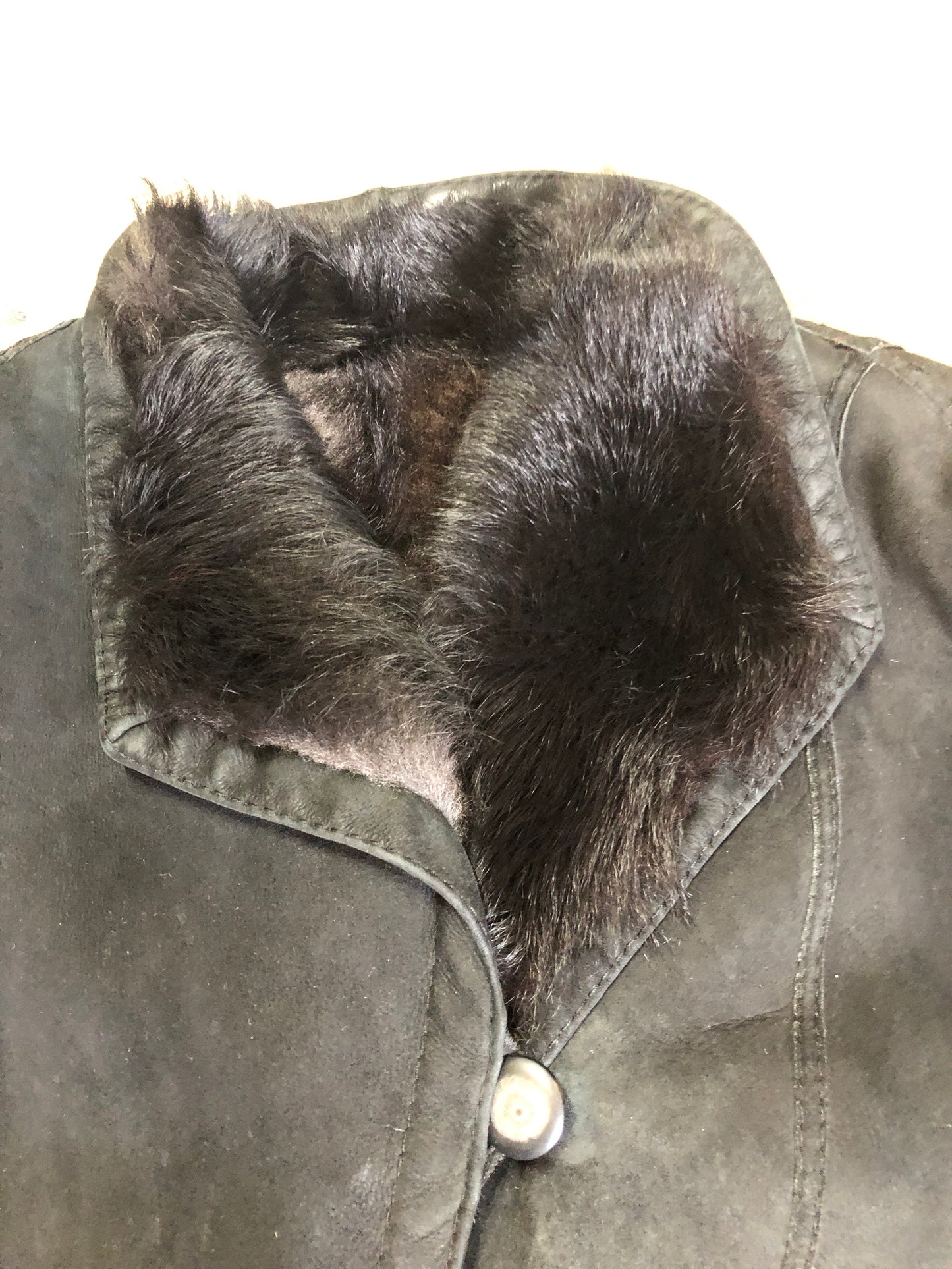 Kingspier Vintage - Black shearling coat with shearling lining, button closures and slash pockets.