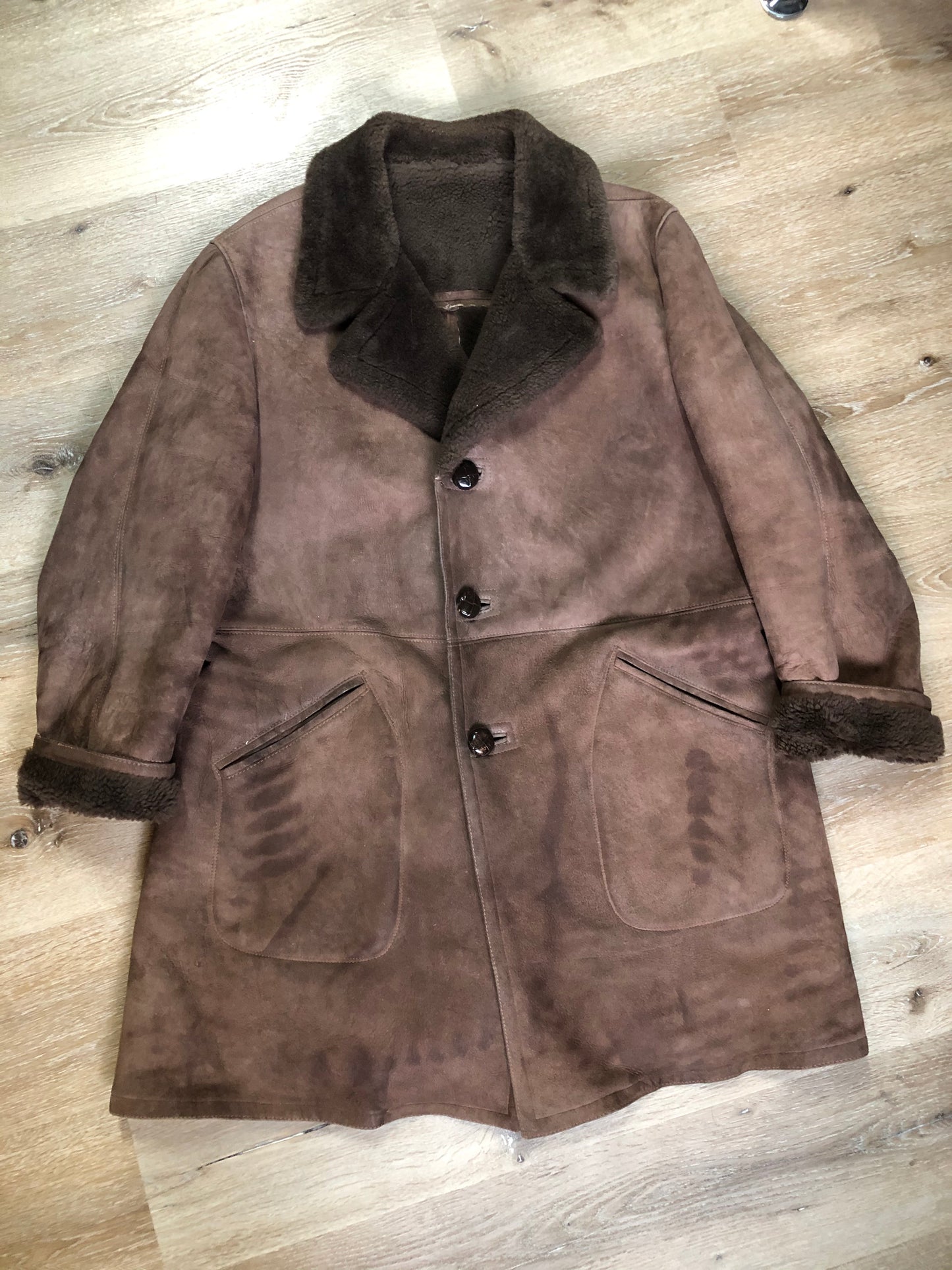 Kingspier Vintage - Bovet medium brown shearling coat. This coat features shearling trim and lining, wooden button closures and patch pockets.