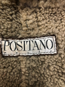 Kingspier Vintage - Positano Pelle dark brown shearling coat. This coat features shearling trim and lining, shall collar, wooden button closures and patch pockets. Made in Turkey. Size small.
