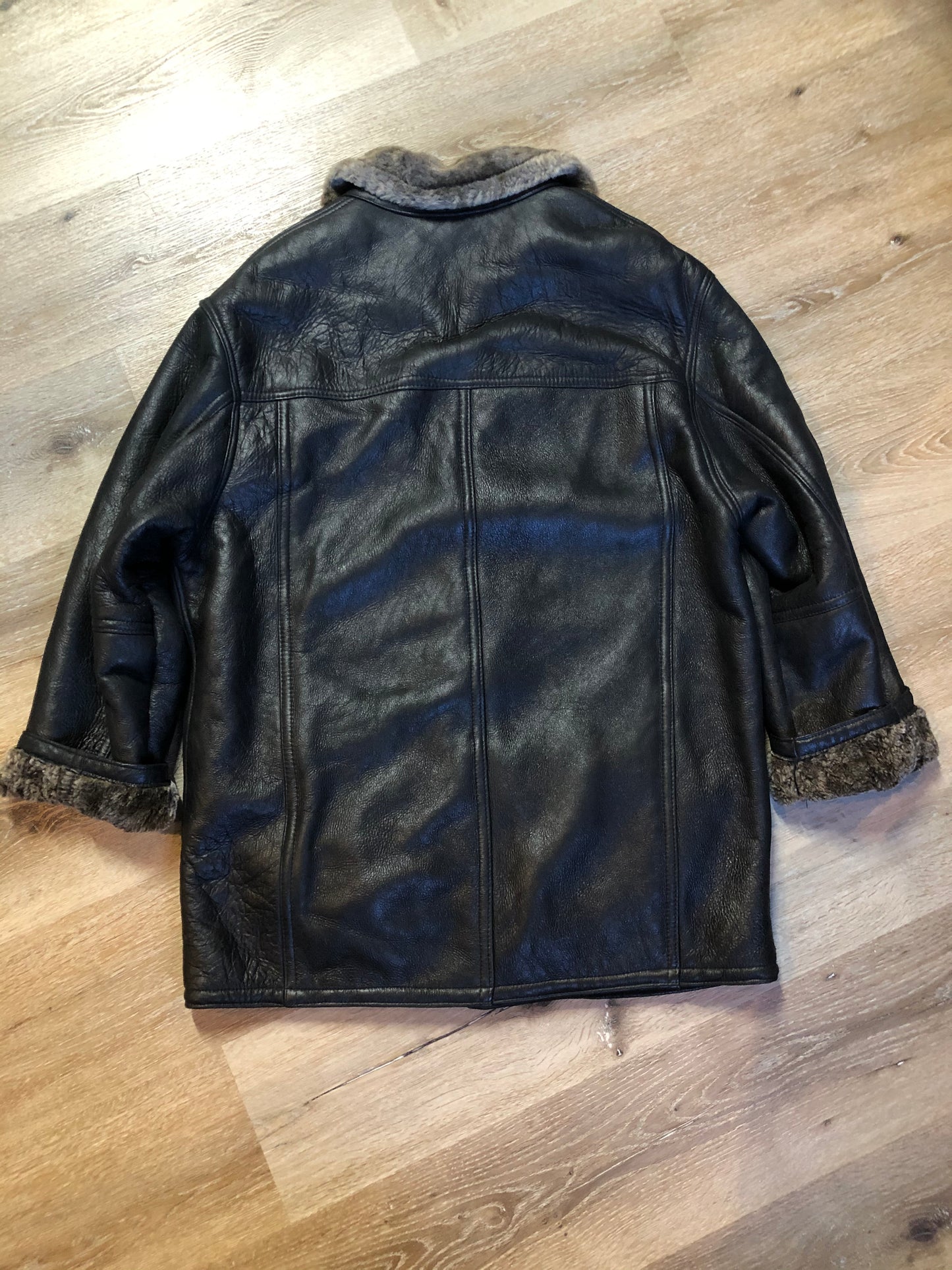 Kingspier Vintage - 2dm black sheepskin coat with shearling trim and lining, button closures and slash pockets.