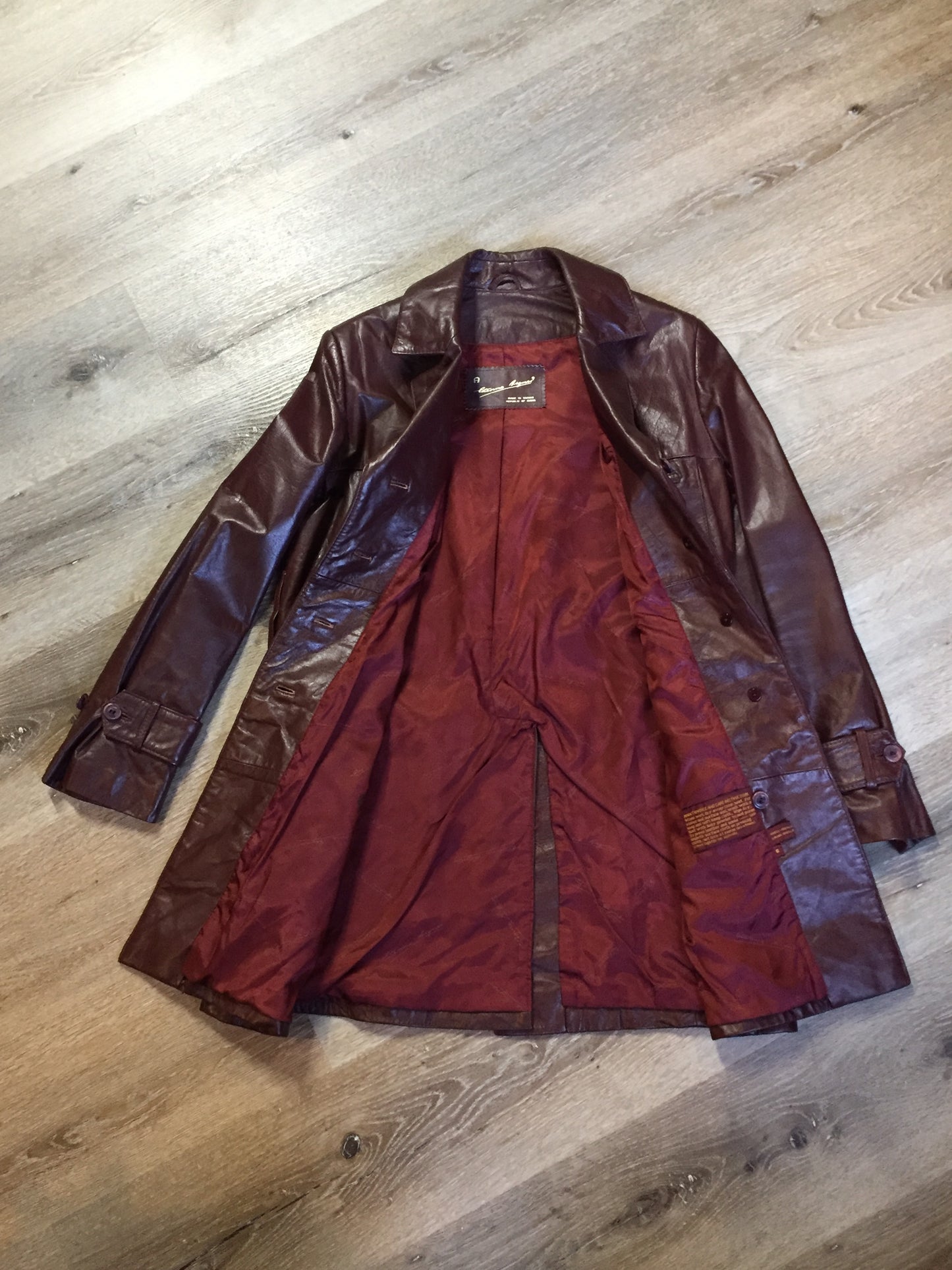 Kingspier Vintage - Etienne Aguier burgundy leather jacket with button closures, patch pockets, belt and “A” decorative details. Size small.