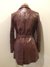 Load image into Gallery viewer, Kingspier Vintage - Etienne Aguier burgundy leather jacket with button closures, patch pockets, belt and “A” decorative details. Size small.
