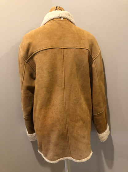 Kingspier Vintage - Timberland tan suede lambskin coat with shearling trim and lining, button closures and slash pockets. Coat is water resistant. Size medium.