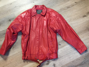 Kingspier Vintage - Zaggara Designs red leather jacket with hidden zipper, slash pockets, inside pocket and a belt at the waist. Size small.