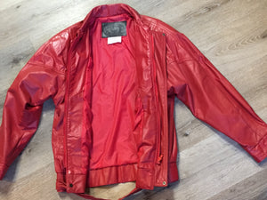 Kingspier Vintage - Zaggara Designs red leather jacket with hidden zipper, slash pockets, inside pocket and a belt at the waist. Size small.