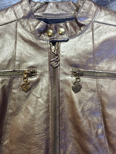 Load image into Gallery viewer, Kingspier Vintage - Rocawear metallic gold leather moto jacket with “RW” detail zippers, chain lace-up detail on sides and “ROCAWEAR” written in chain across the back. There is a front zipper, two horizontal zip pockets on the chest, two snap closures on the stand up collar and a pocket on the inside. Size small.
