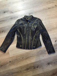 Kingspier Vintage - Baby Phat black leather moto jacket with gold piping and “Baby Phat” embroidered on the chest, front zipper and two vertical zip pockets. A pattern is stitched into the elbows and “Baby Phat” is stitched across the back. Size small.