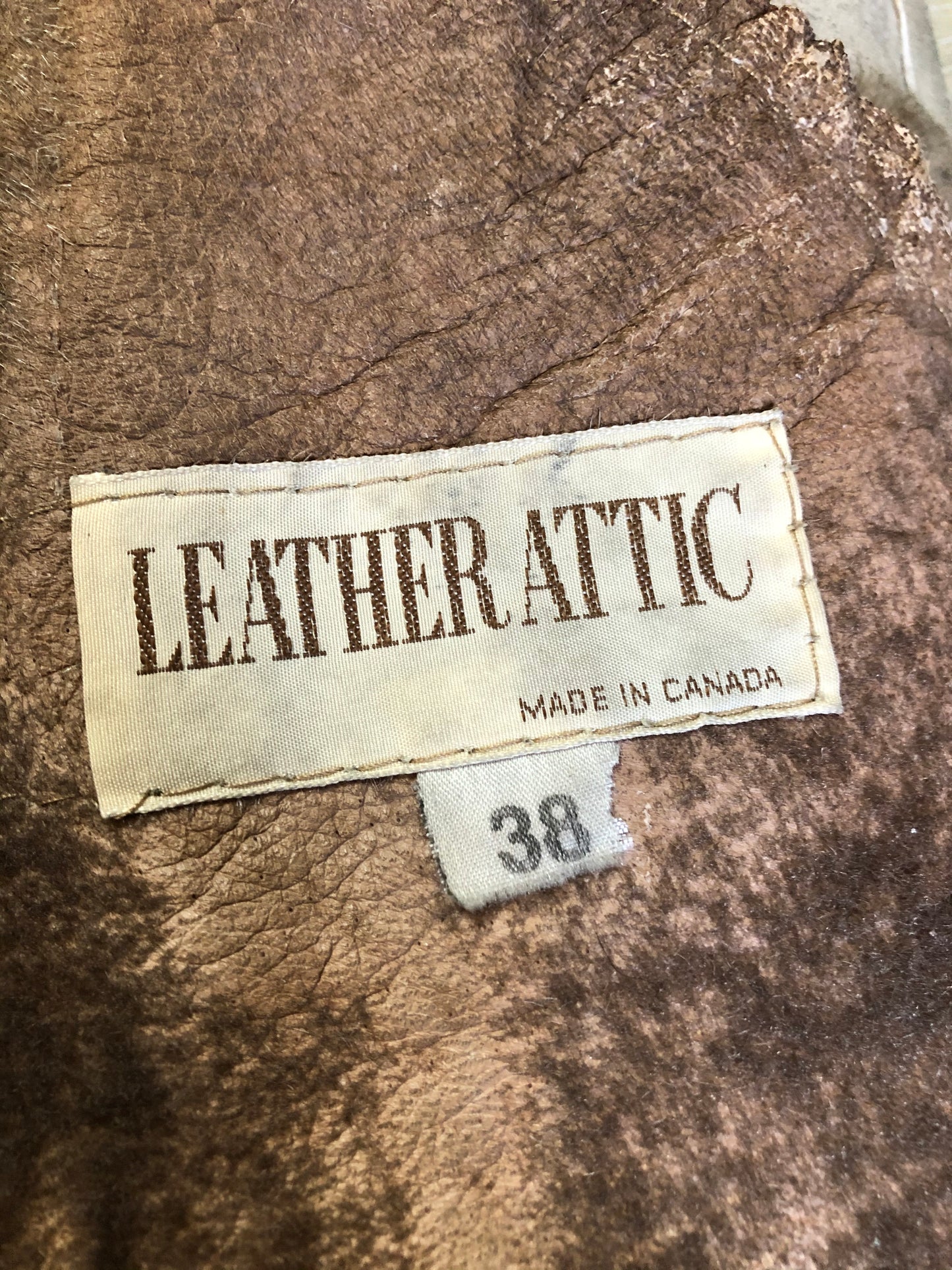 Kingspier Vintage - Leather Attic light brown suede coat with shearling lining, button closures and vertical pockets. Made in Canada. Size 38.