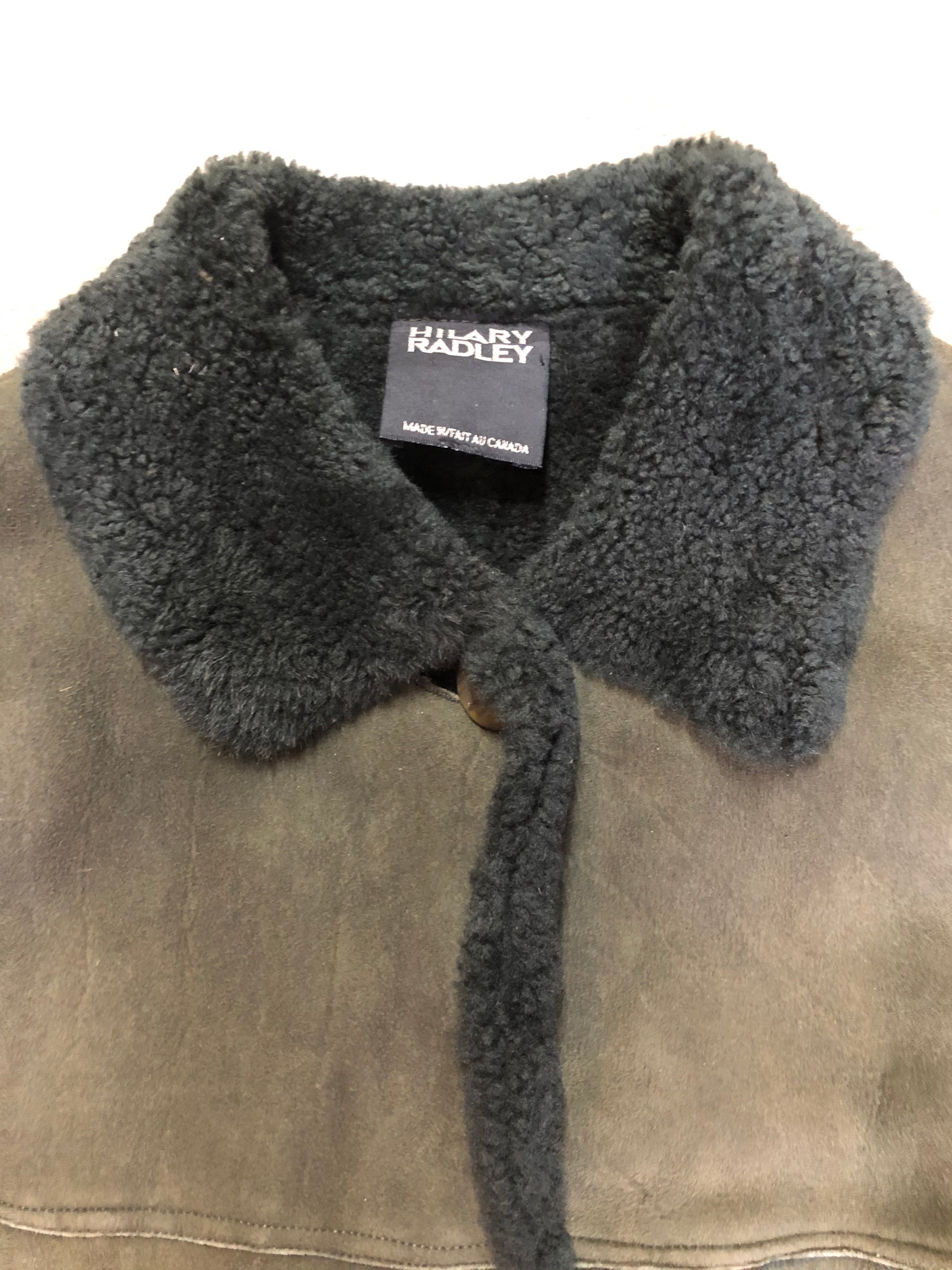 Hilary Radley green shearling coat with button closures and patch pockets. Made in Canada.