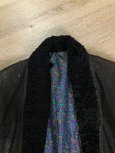 Load image into Gallery viewer, Kingspier Vintage - Jeno de Paris double breasted black leather coat with Persian lamb trim, colourful paisley lining, button closures and slash pockets. Made in Canada.

